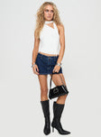Low-rise denim mini skort Belt looped waist, zip & button fastening, faux back pockets Non-stretch material, unlined
