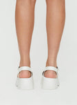 Sandals Strappy upper, faux leather, silver-toned hardware, buckle fastening, platform base,        treaded sole, rounded toe