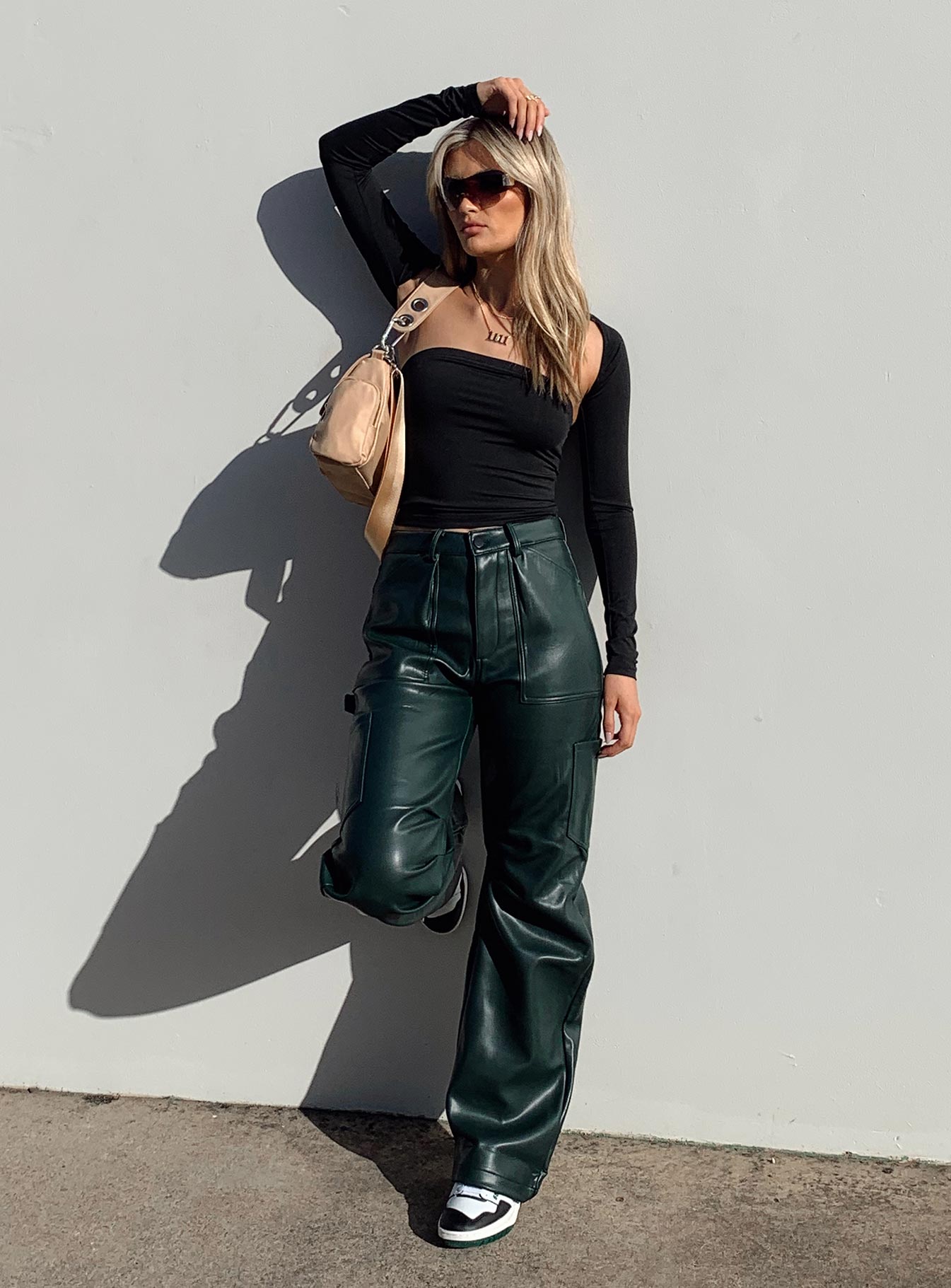 Pants 100% PU Faux leather material  Zip & button fastening  Belt looped waist  Six pockets  Pleated at inner thigh  Wide leg 