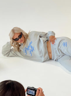 side view of model wearing Princess Polly Princess Polly Hooded Sweatshirt Cursive Text Grey / Blue regular 