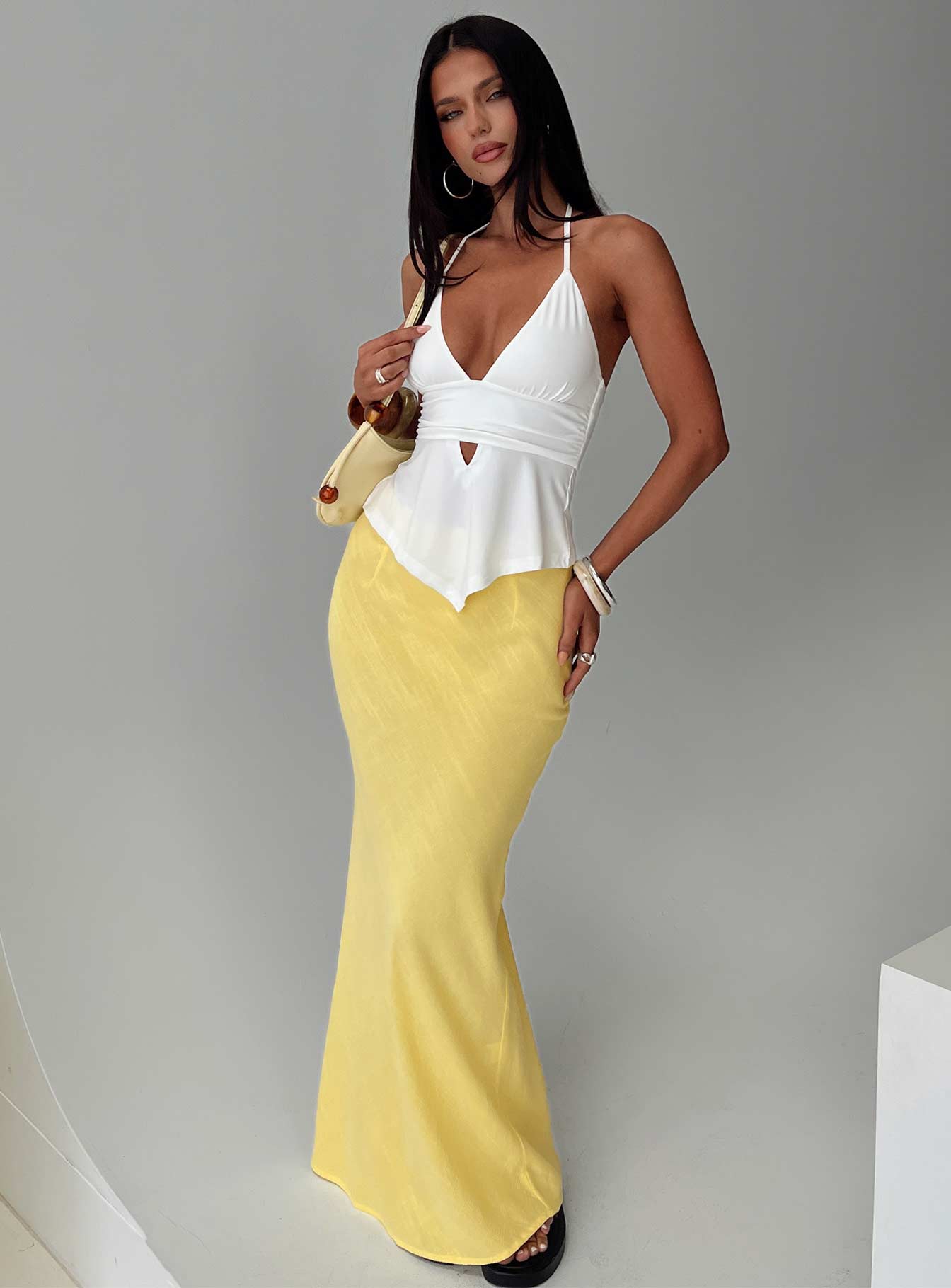   side view of model wearing Princess Polly Jodie Maxi Skirt Lemon Yellow Maxi Skirts Skirts 