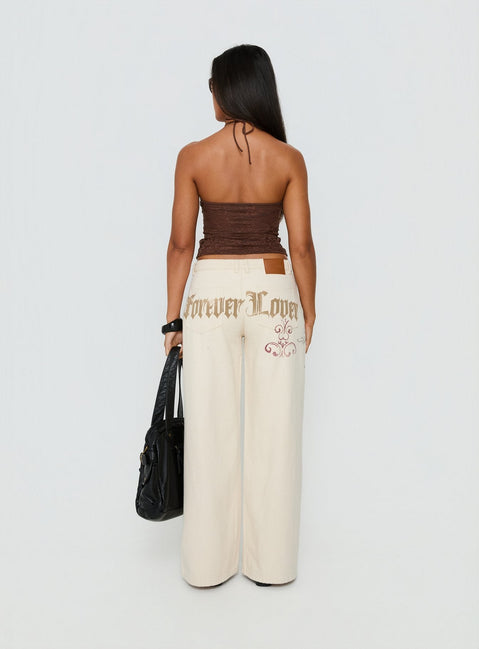 back view of model wearing Princess Polly Than Forever Love Graphic Denim Jeans Cream Low Rise Jeans Jeans 
