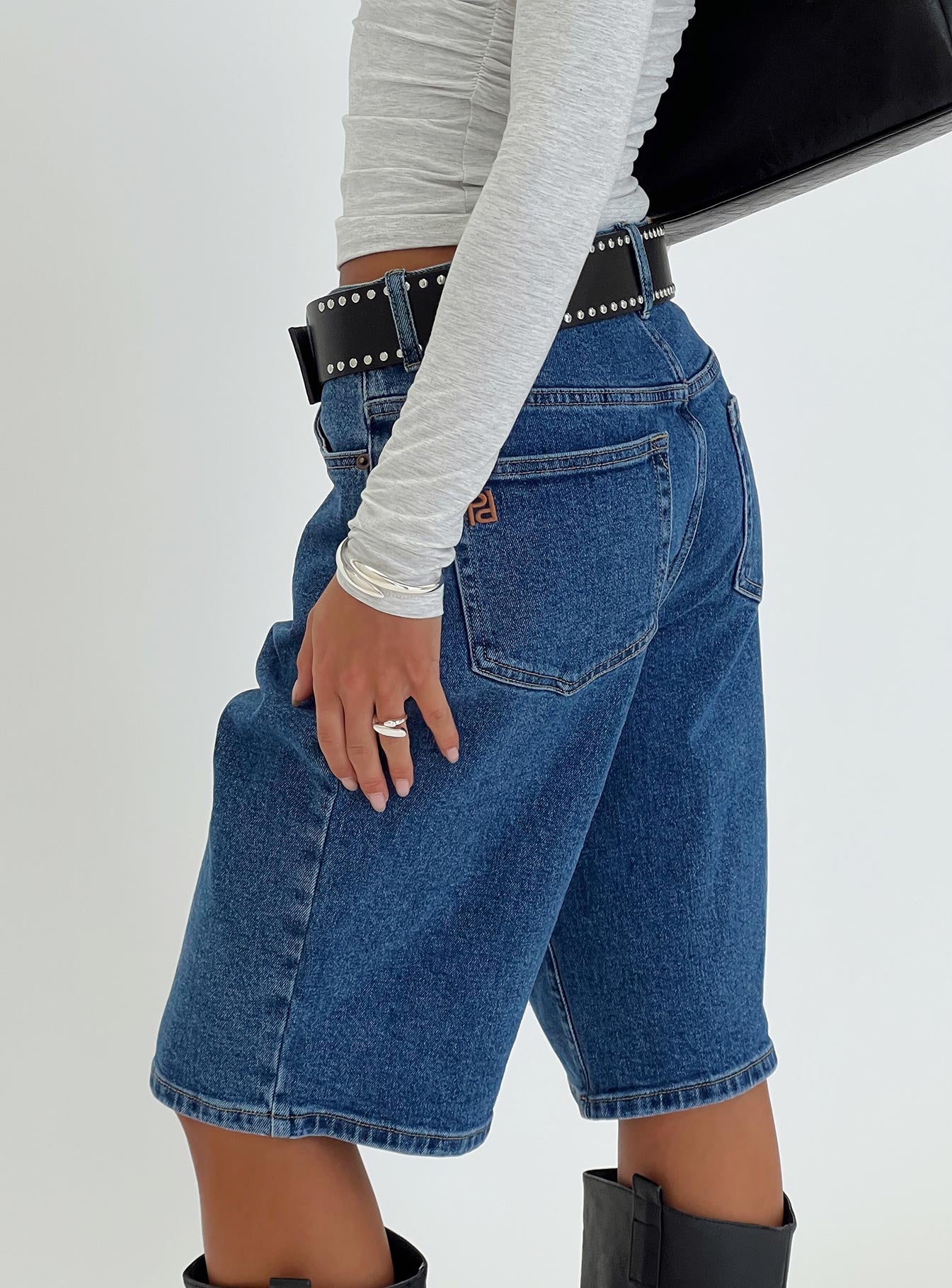 back view of model wearing Princess Polly Retro Dream Mid Rise Longline Denim Shorts Mid Wash Low Rise Shorts 