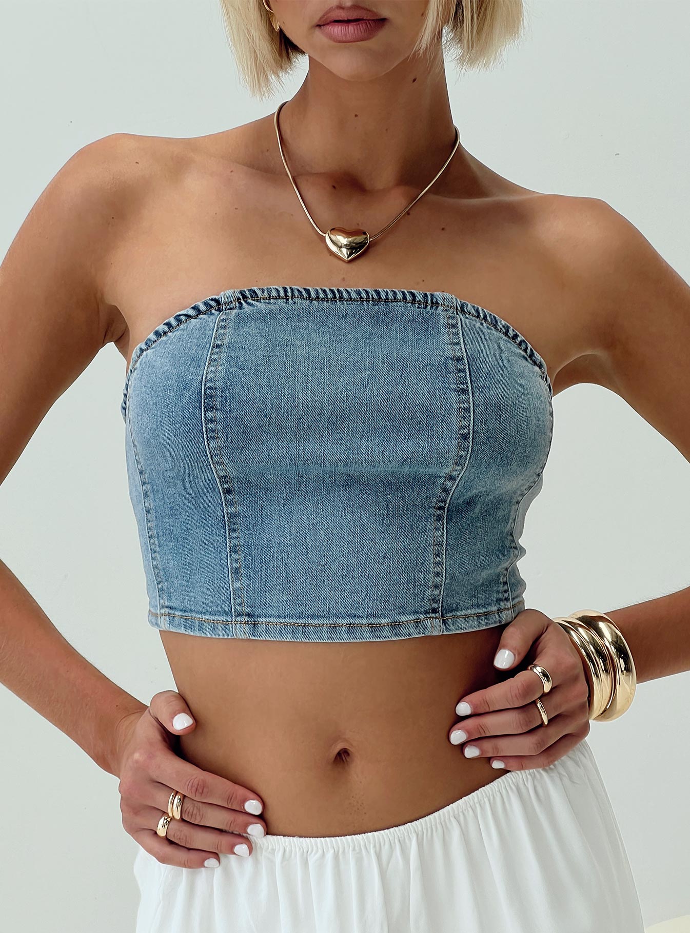 Strapless denim top Inner silicone strip at bust, shirred band at back Good stretch, unlined 
