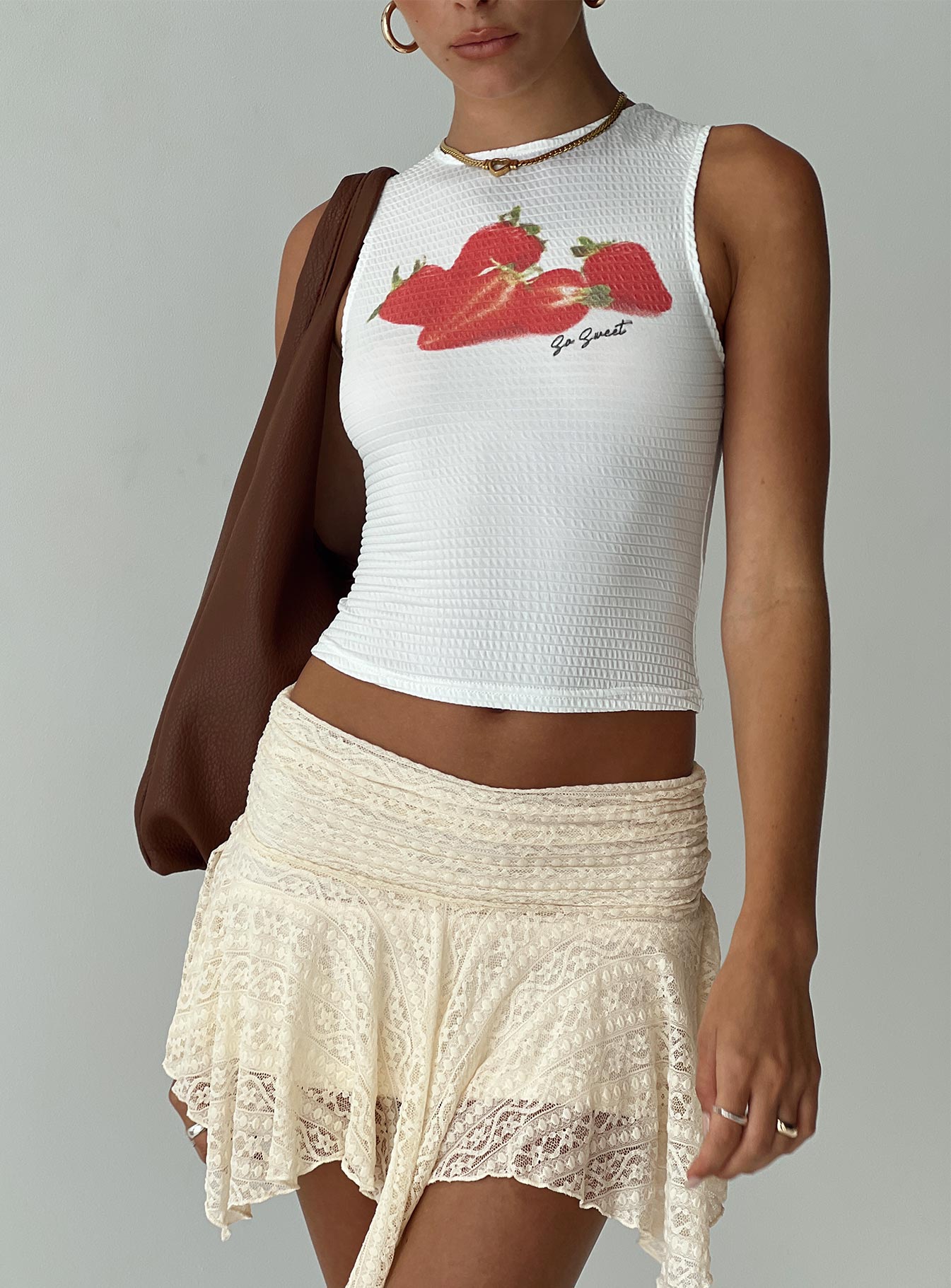 side view of model wearing Princess Polly Oh So Sweet Top White Sleeveless Crew Neck 