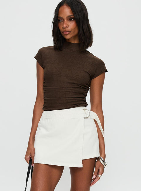   side view of model wearing Princess Polly Elinora Wrap Mini Skirt White Mini Skirts 