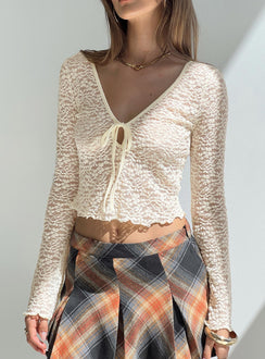 Long sleeve top  Lace material, scoop neckline, tie detail at bust, slightly flared sleeves, sheer design Good stretch, unlined