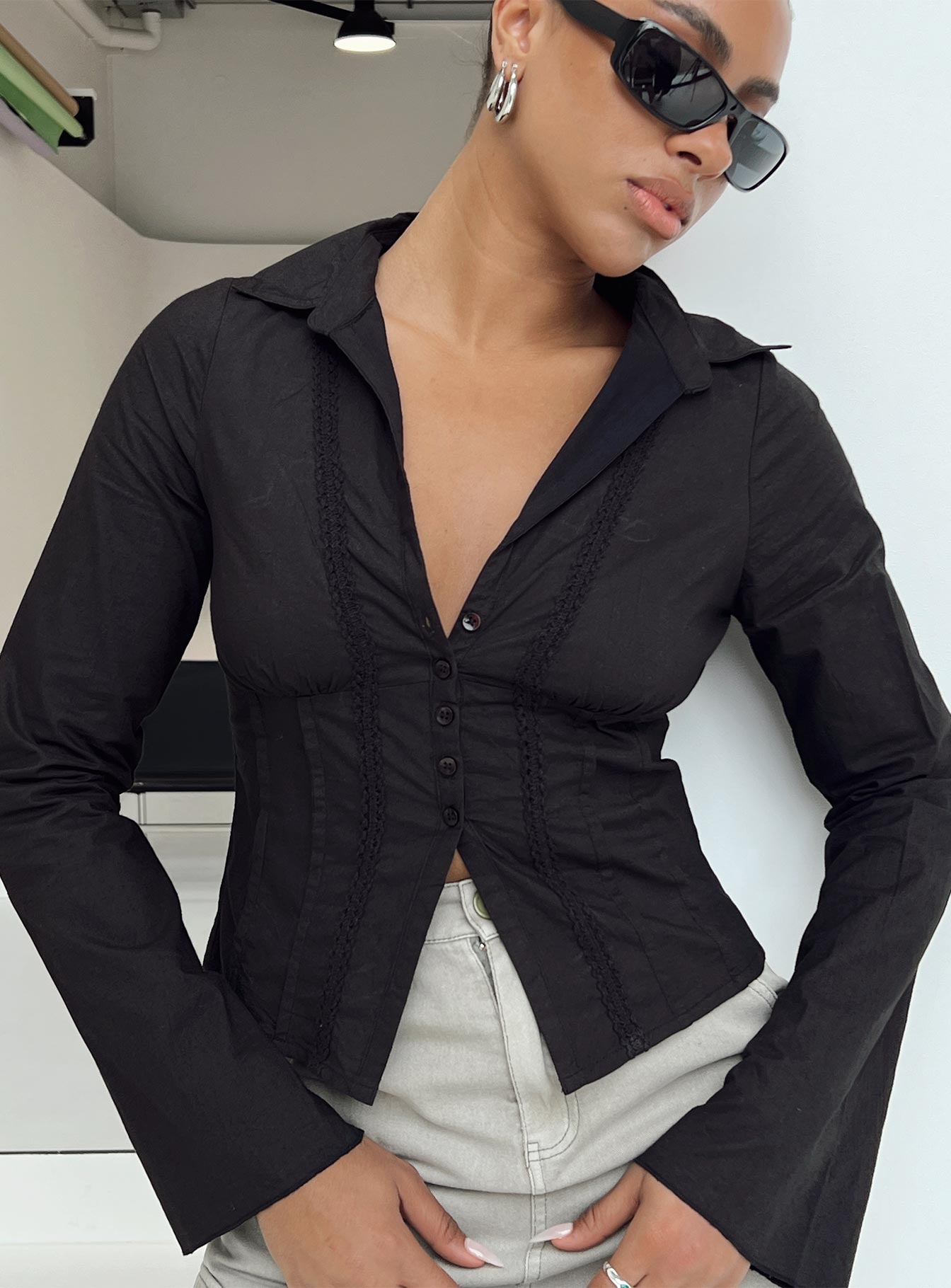 Shirt V neckline Classic collar Slight ruching at bust Button fastening at front Knitted lace detail Flared cuff