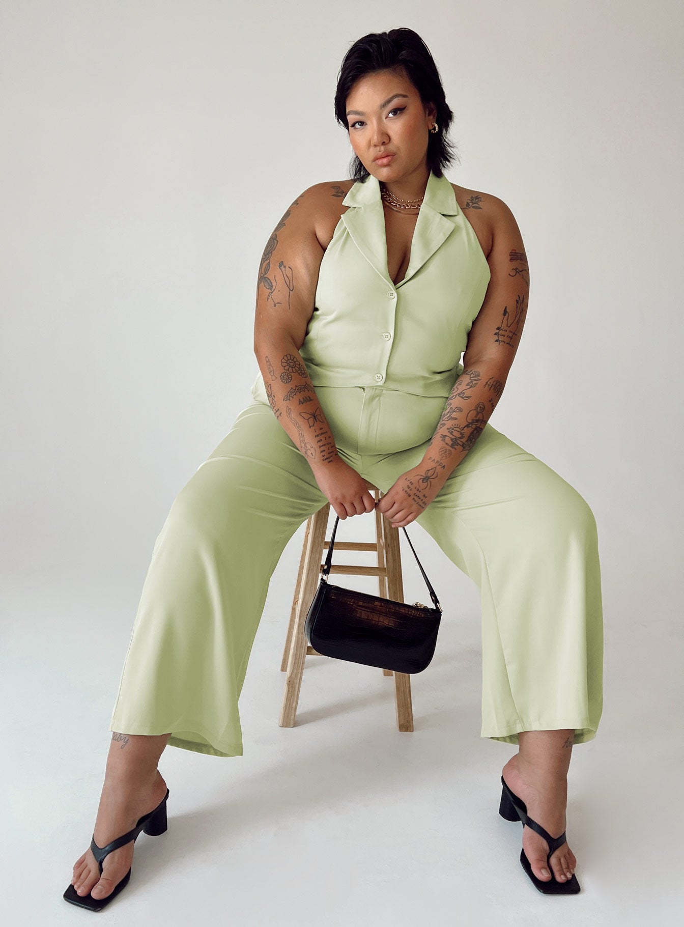 Matching set High waisted pants  Zip & button fastening  Elasticated back band  Belt looped waist  Twin hip pockets Wide leg  Vest top  Lapel collar  Button front fastening 