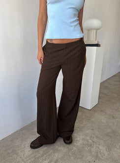 side view of model wearing Princess Polly Khane Low Rise Wide Leg Pant Brown Pinstripe Low Rise Pants 