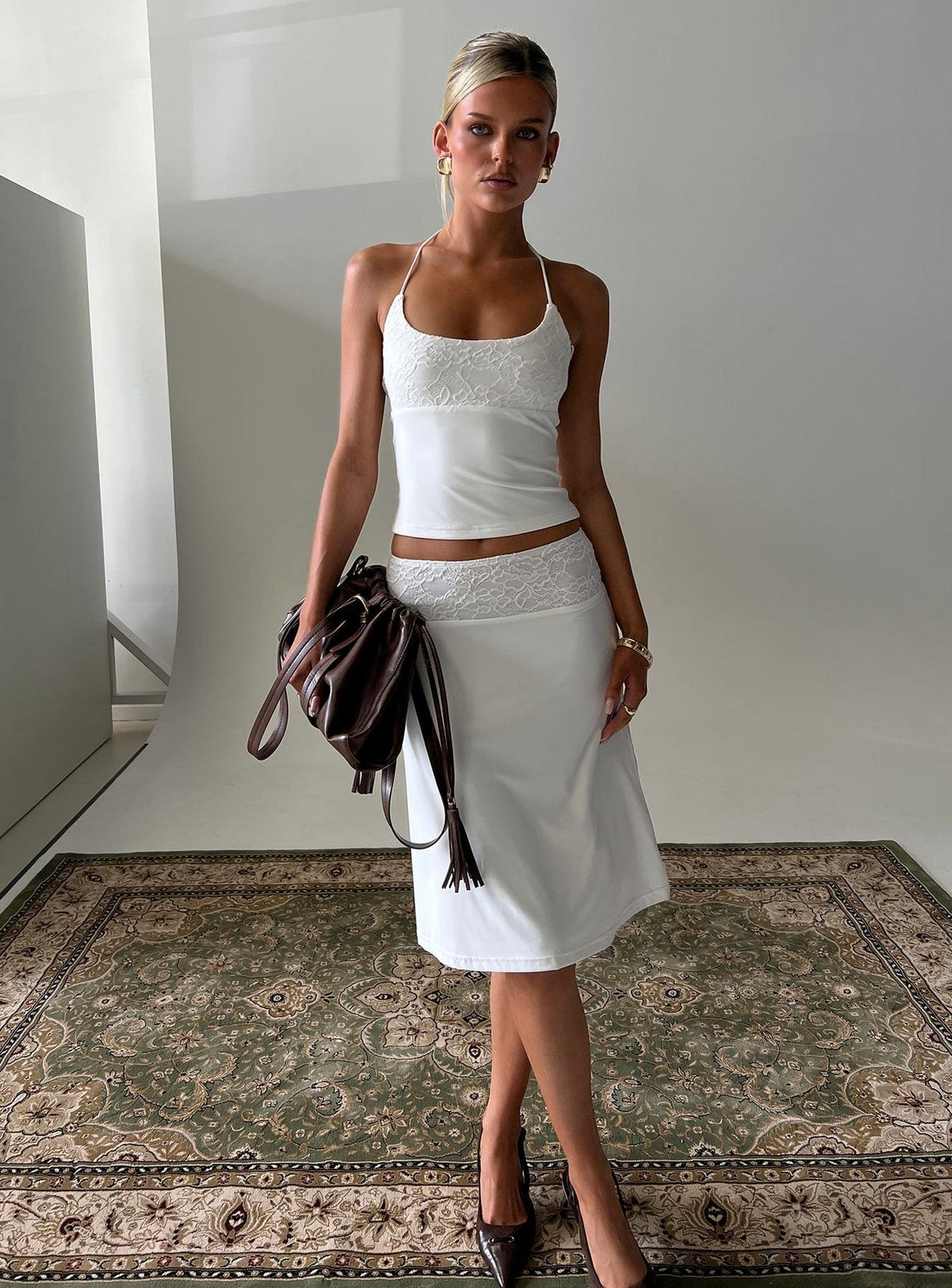 Showcasing the Zenaide Lace Detail Midi Skirt White womens-skirts with midi length front view of model wearing Princess Polly