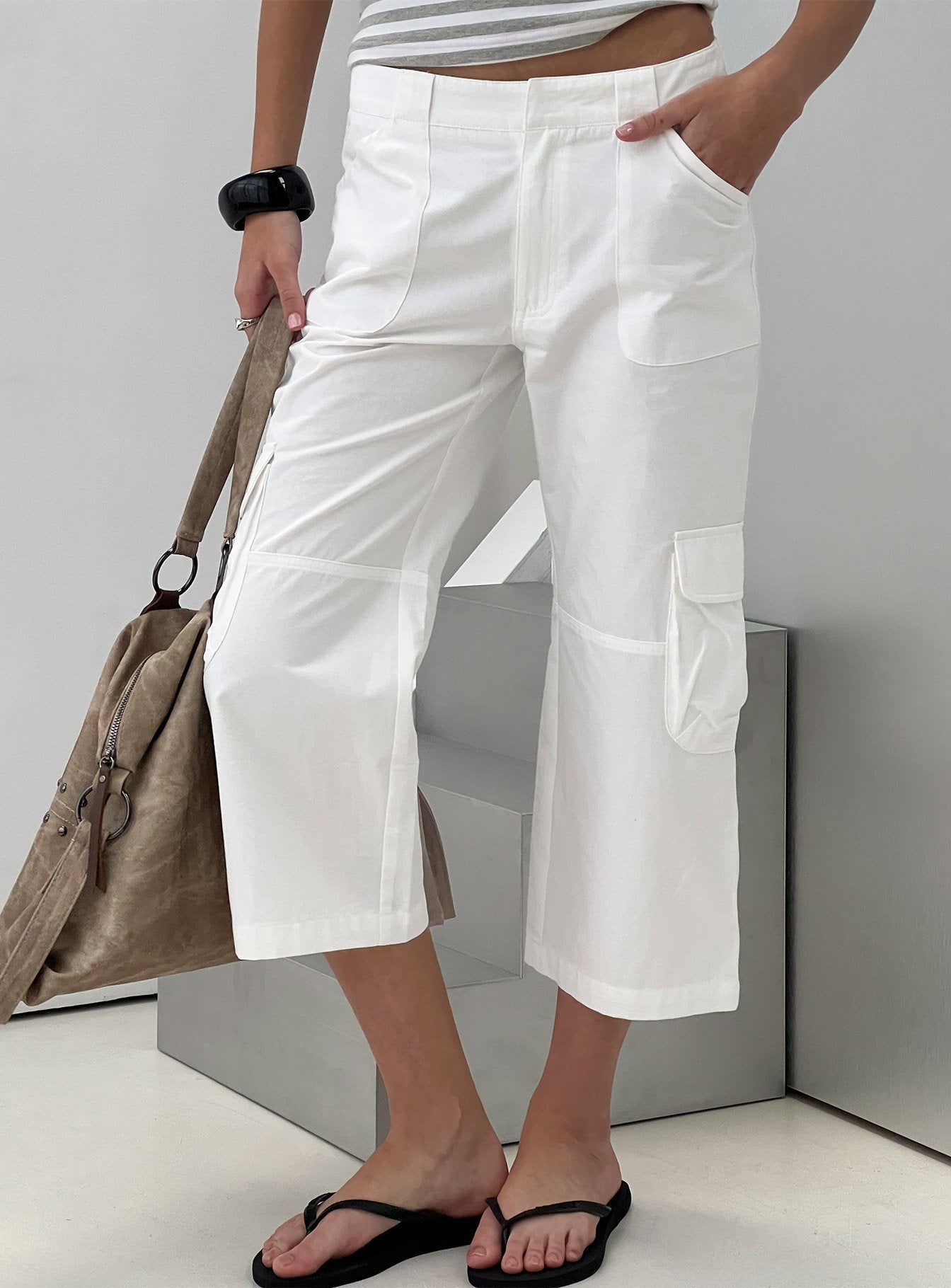 Showcasing the Indee Cropped Cargo Pants White womens-regular-pants with high-rise side view of model wearing Princess Polly