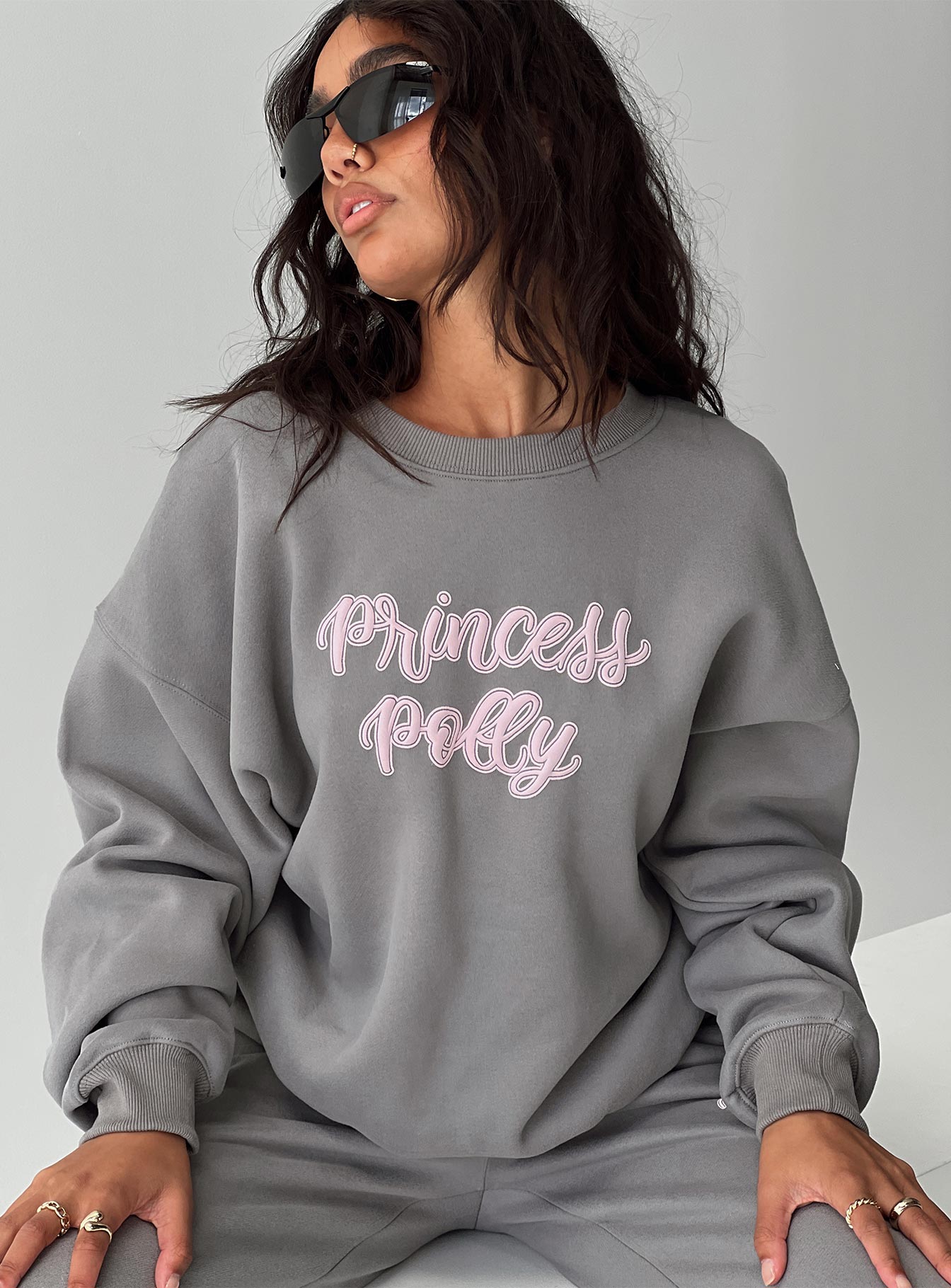 front view of model wearing Princess Polly Princess Polly Crew Neck Sweatshirt Puff Text Charcoal Long 