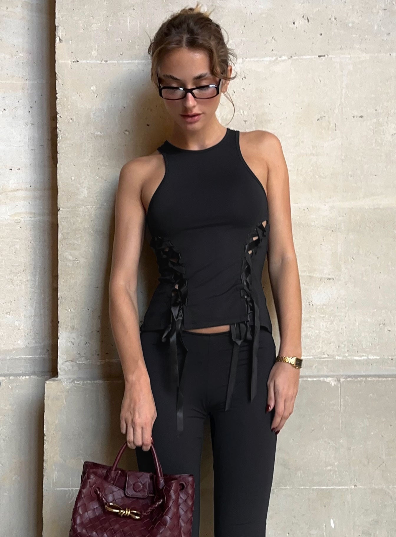 side view of model wearing Princess Polly Bisous Top Black Sleeveless Crew Neck 