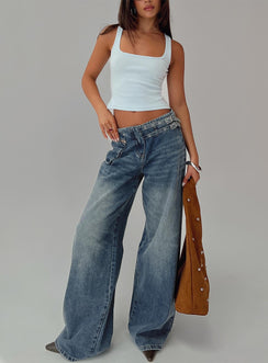 front view of model wearing Princess Polly Paltrow Mid Rise Wide Leg Cargo Jeans Mid Blue Wash Petite Mid Rise Jeans 