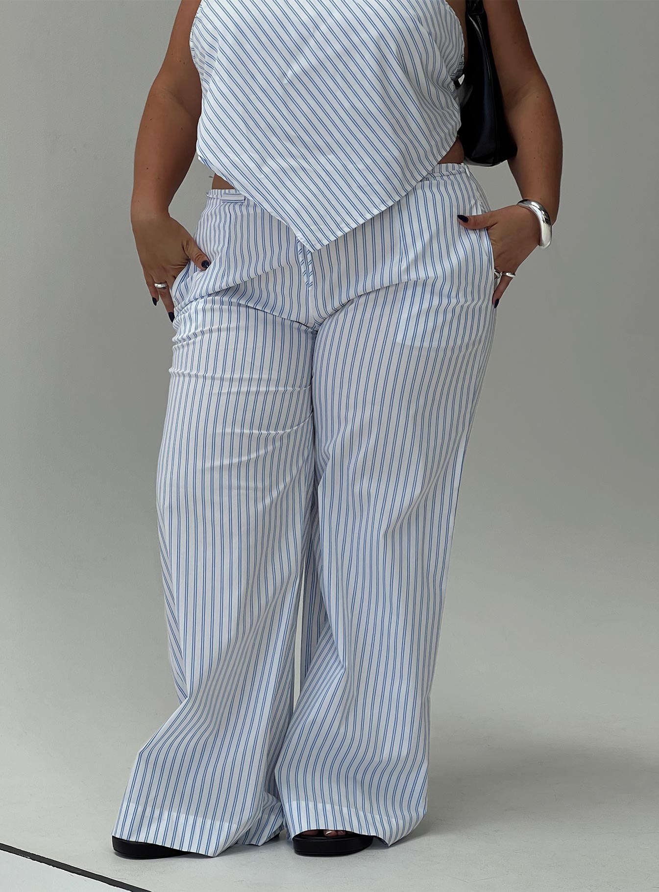 front view of model wearing Princess Polly Collied Low Rise Pants Blue / White Stripe Curve High Waisted Pants 