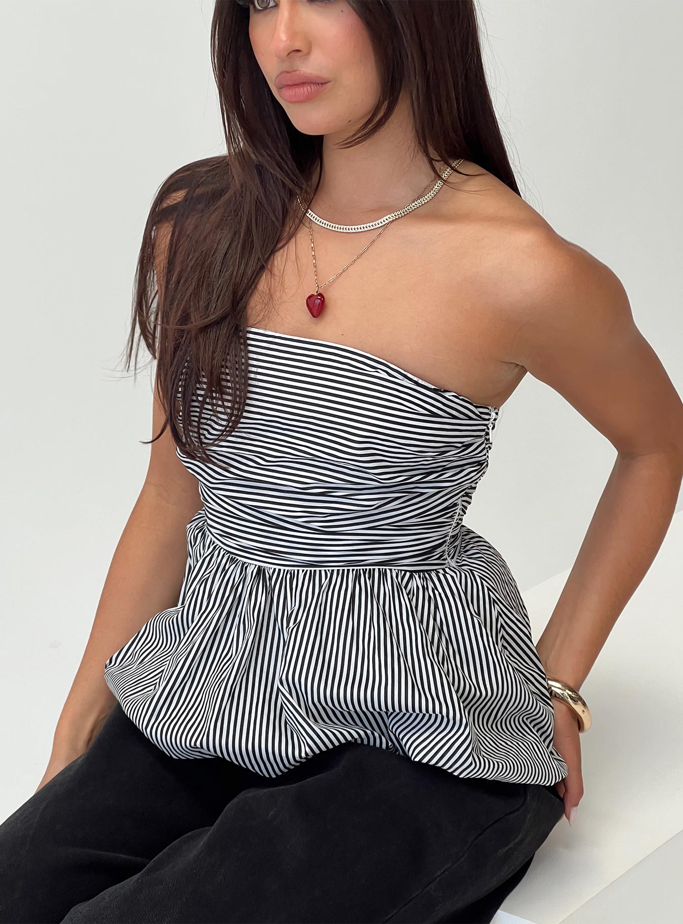 side view of model wearing Princess Polly Selenea Bubble Hem Top Black / White Sleeveless straight 