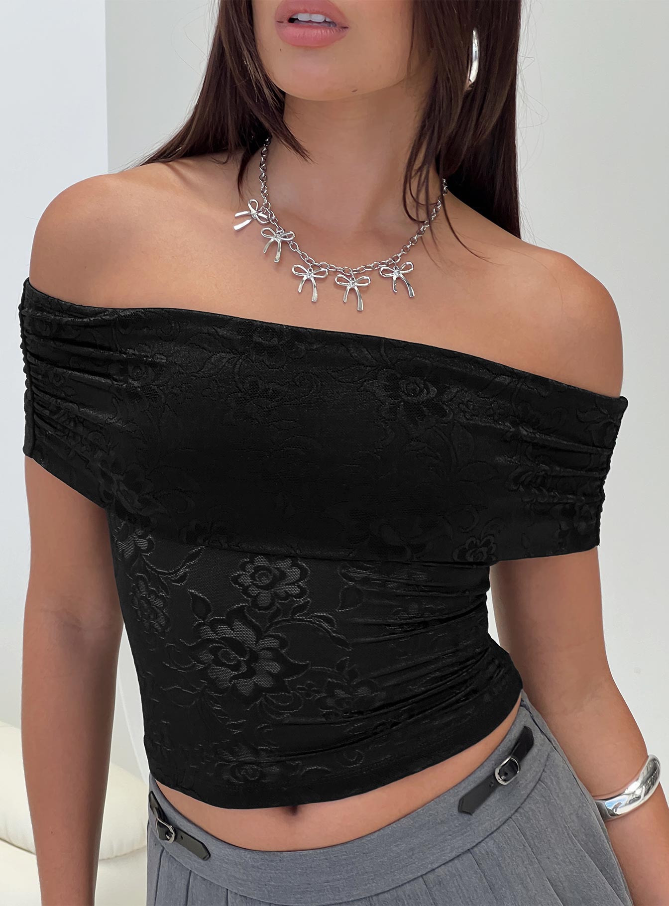 side view of model wearing Princess Polly Werrender Off The Shoulder Top Black Short Sleeves straight 
