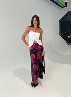   side view of model wearing Princess Polly Cooperi Maxi Skirt Black / Red Floral Maxi 