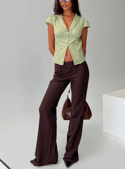 front view of model wearing Princess Polly Kinkirk Flared Pants Brown Pinstripe Low Rise Pants 