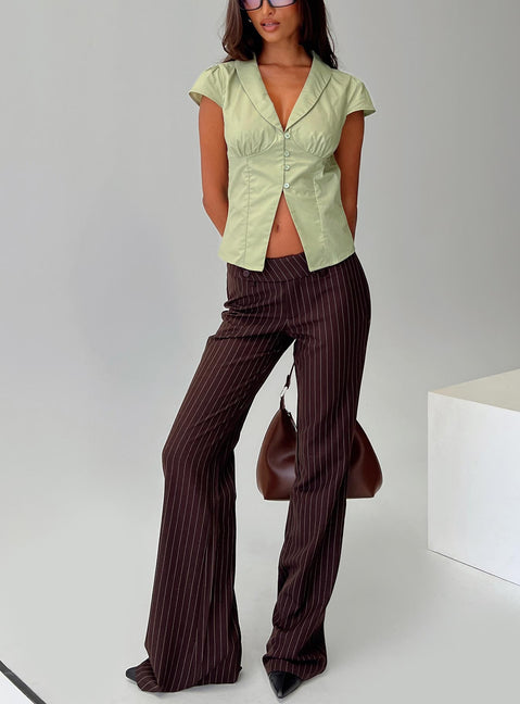 front view of model wearing Princess Polly Kinkirk Flared Pants Brown Pinstripe Low Rise Pants 
