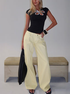 front view of model wearing Princess Polly Ramos Low Rise Wide Leg Jeans Butter Lemon Low Rise Jeans 