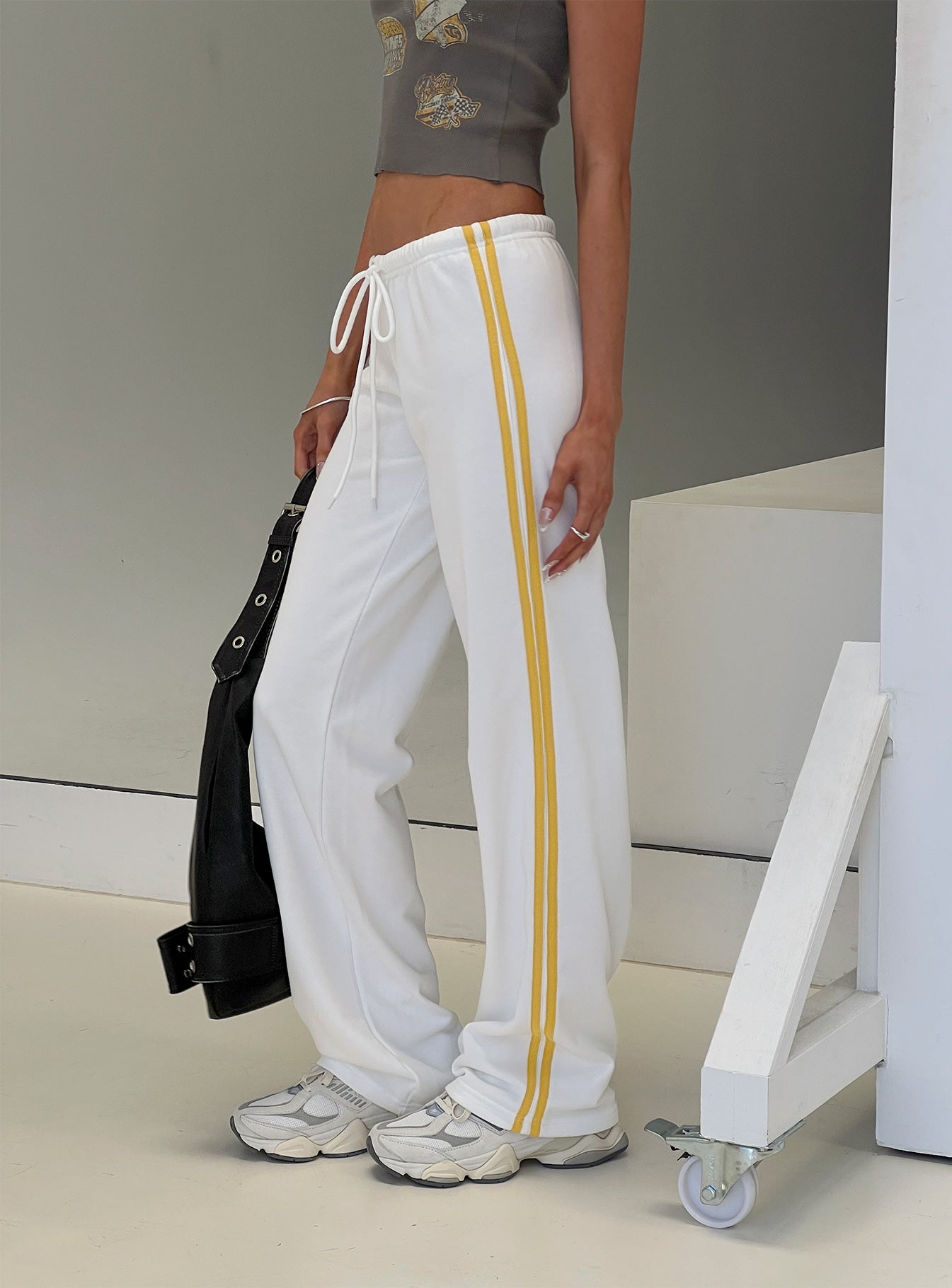 side view of model wearing Princess Polly Elation Low Rise Straight Leg Track Pant White Low Rise Pants 