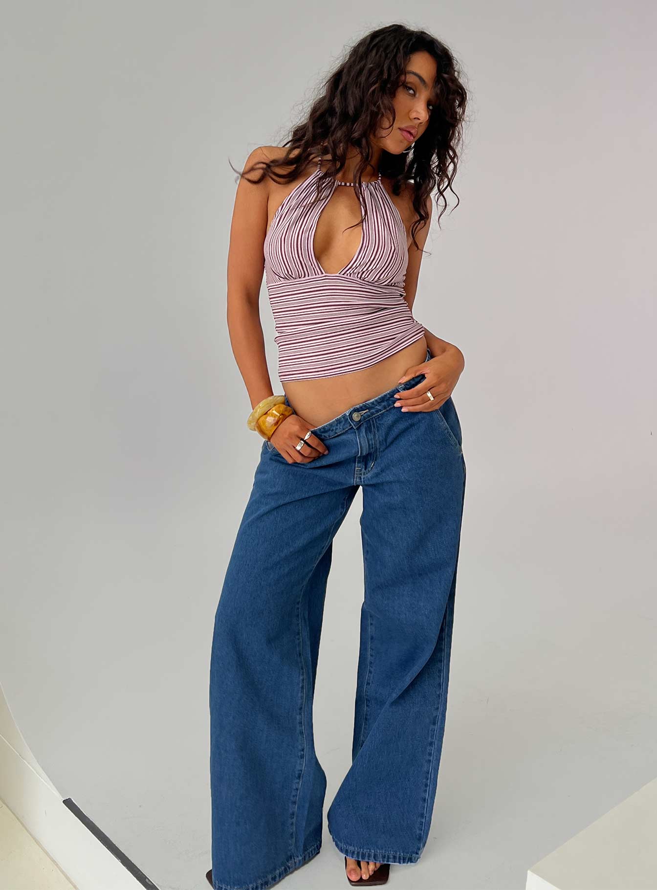 side view of model wearing Princess Polly Polaris Mid Rise Straight Leg Jeans Mid Blue Mid Rise Jeans 