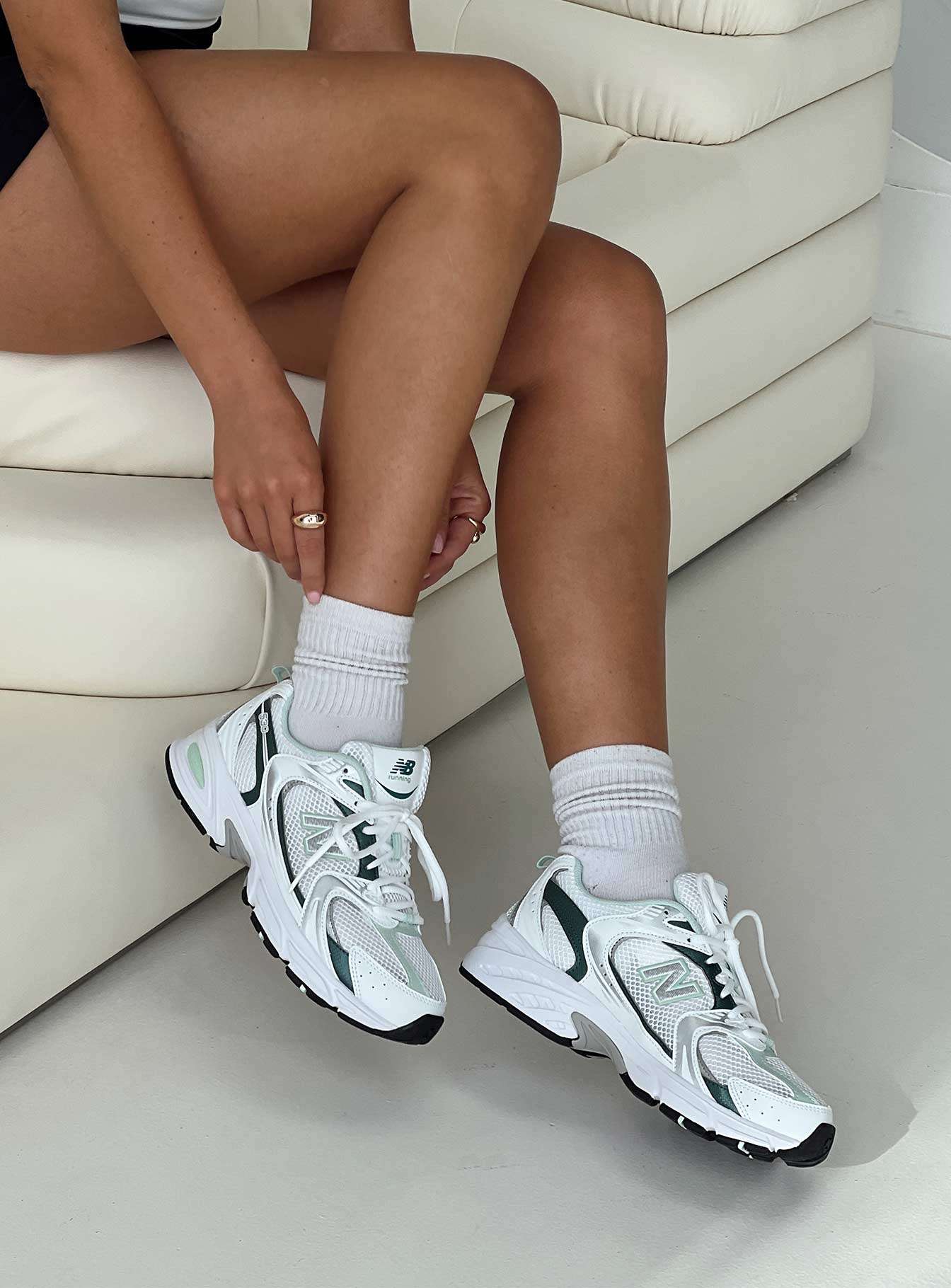 Mesh netting throughout, lace-up fastening, pull tab at heel