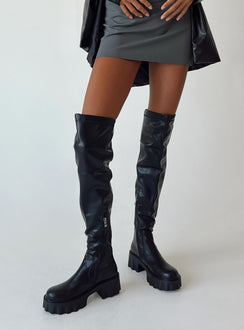Thigh high boots Faux leather material Platform base Rounded toe Zip fastening at 