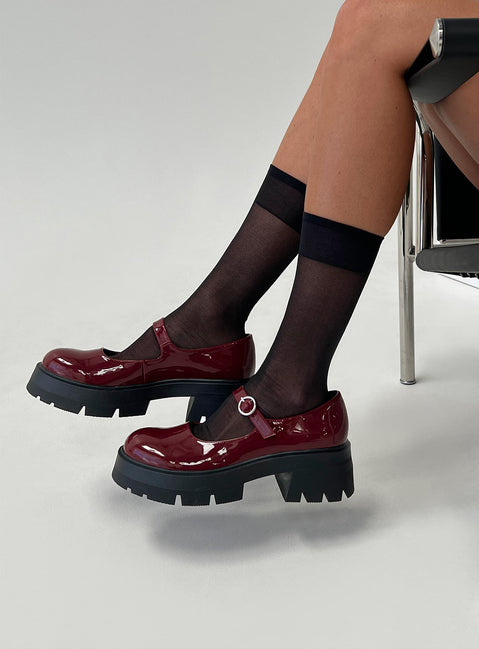 Faux patent leather loafer Platform base, treaded sole, single strap upper, silver-toned hardware, buckle fastening