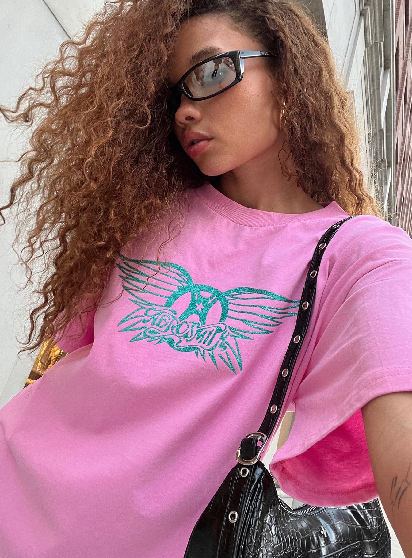 Front view of model wearing  front Princess Polly Half Sleeves Crew Neck  Aerosmith Oversized Tee Pink