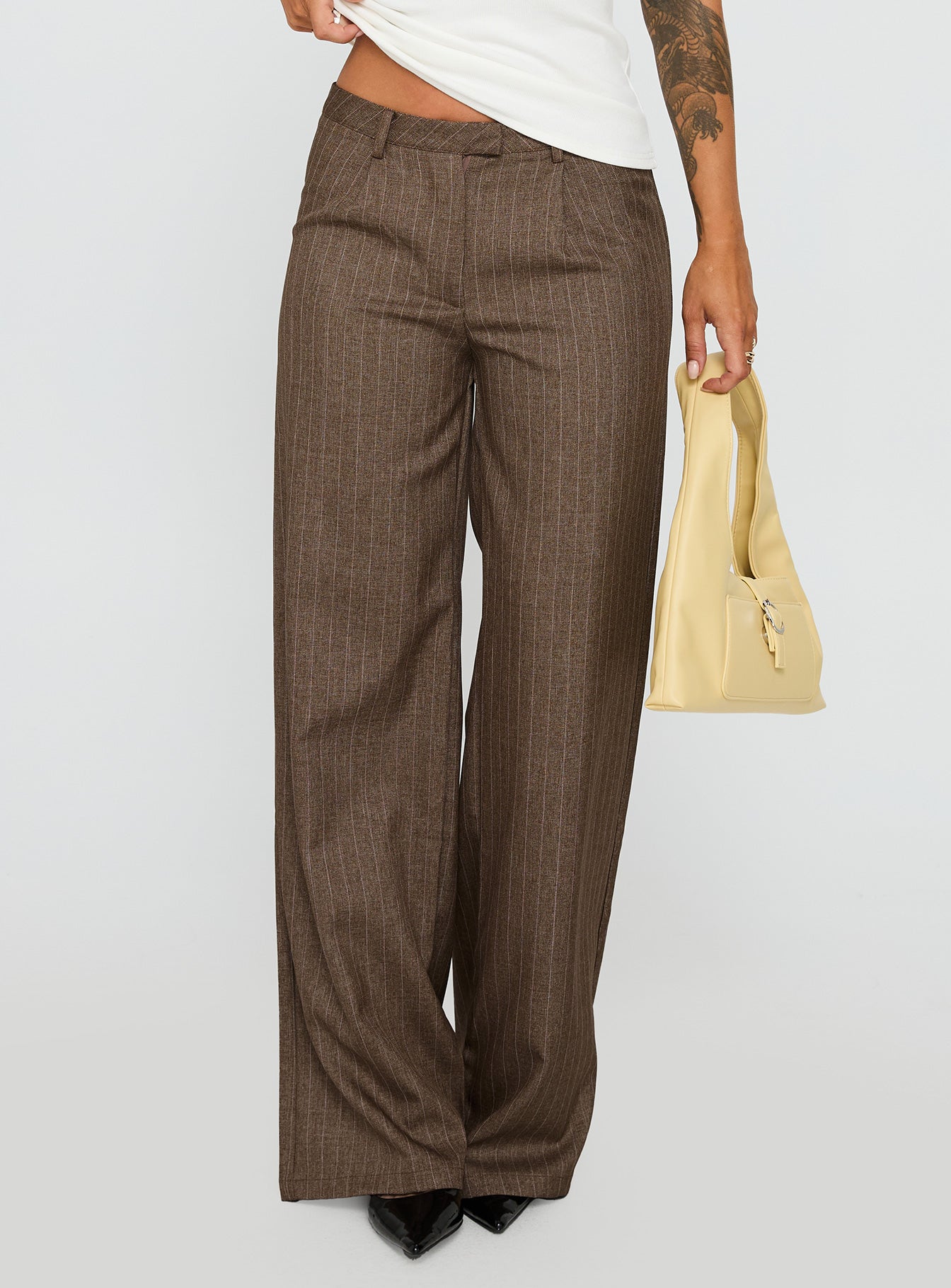 side view of model wearing Princess Polly Broadcast Pants Beige Pinstripe Low Rise Pants 