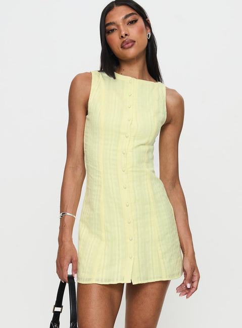 side view of model wearing Princess Polly Mimsie Embroidered Mini Dress Lemon Boat Neck 