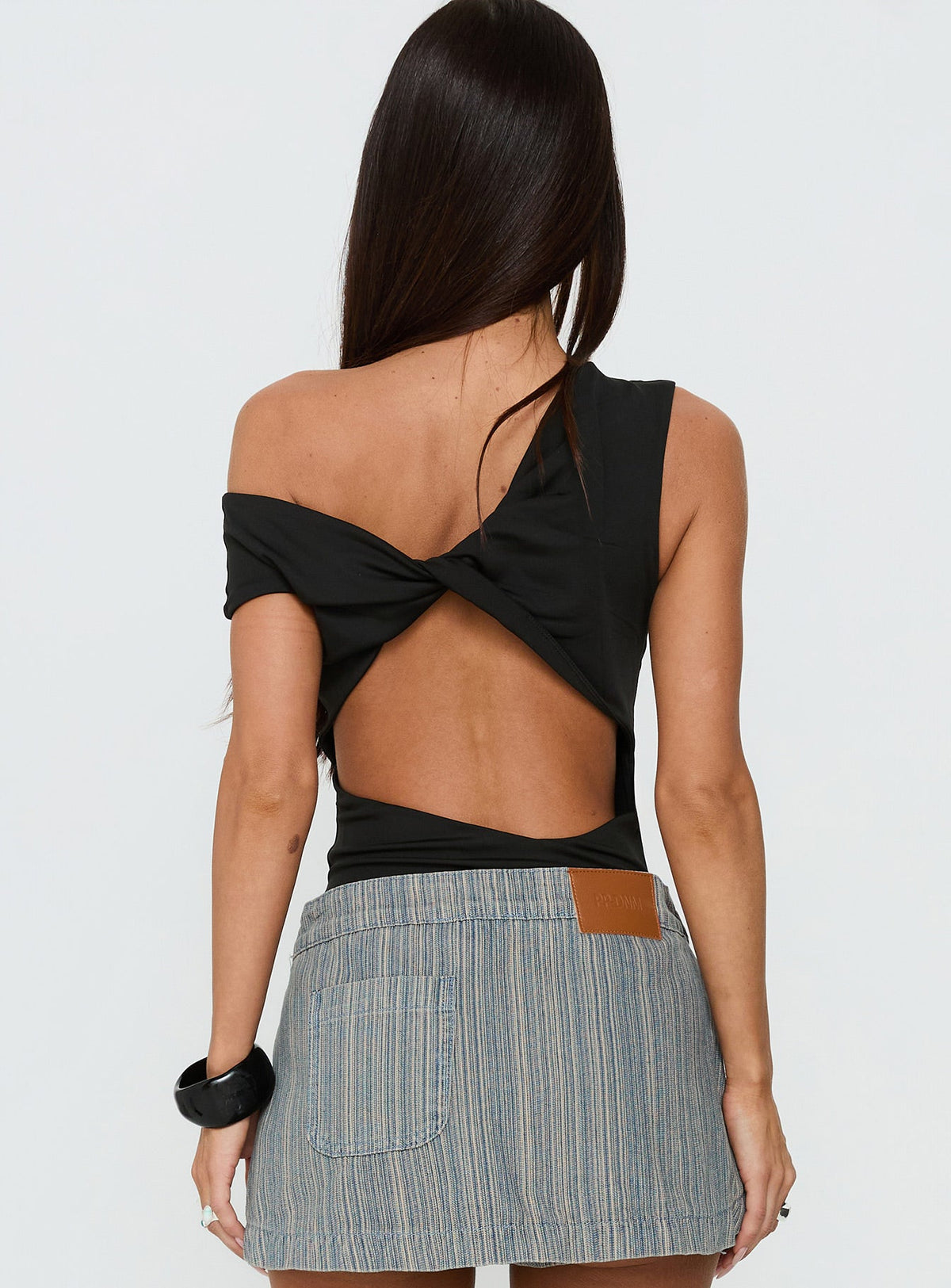 back view of model wearing Princess Polly Back To Back Off Shoulder Twist Back Bodysuit Black Short Sleeve Bodysuit 