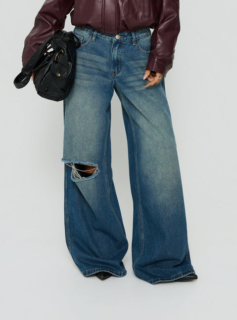 Featuring the Ramos Low Rise Wide Leg Distressed Jeans Dark Indigo womens-jeans with ripped details Princess Polly