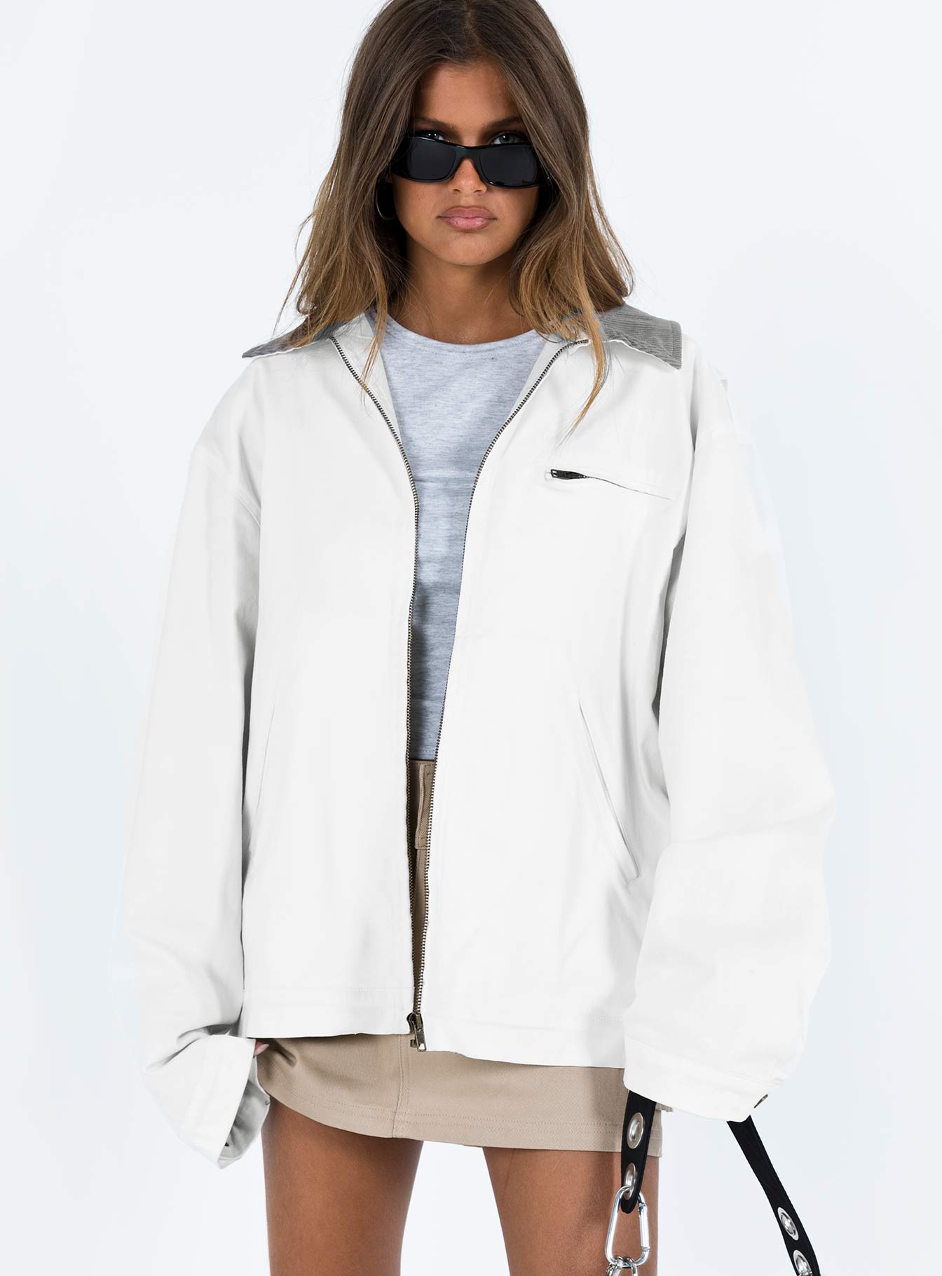 White jacket Classic collar Zip fastening at front Twin hip pockets  Chest pocket Press button fastening at cuff