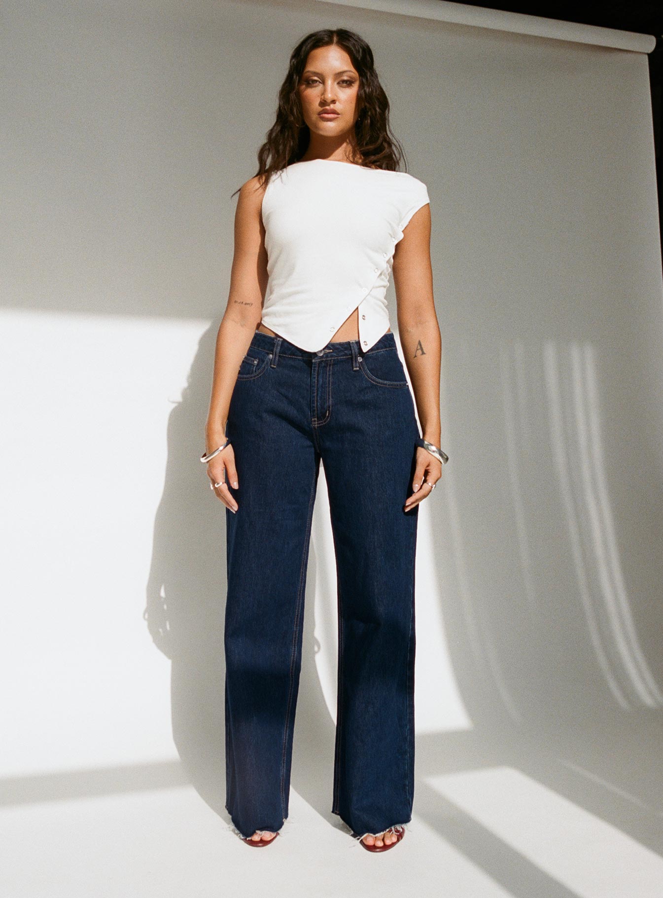 front view of model wearing Princess Polly Darla Low Rise Straight Jean Dark Wash Petite Low Rise Jeans 