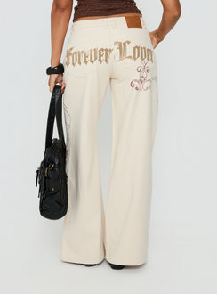 back view of model wearing Princess Polly Than Forever Love Graphic Denim Jeans Cream Low Rise Jeans Jeans 