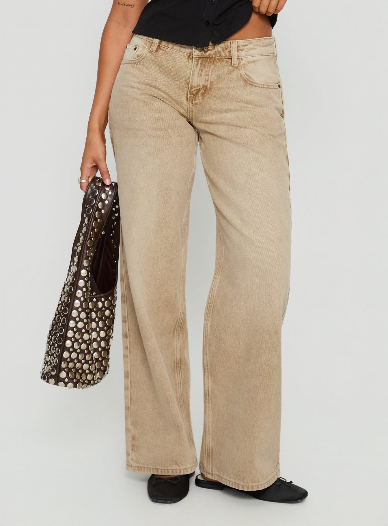 side view of model wearing Princess Polly Ellanor Low Rise Straight Leg Jeans Tan Low Rise Jeans 