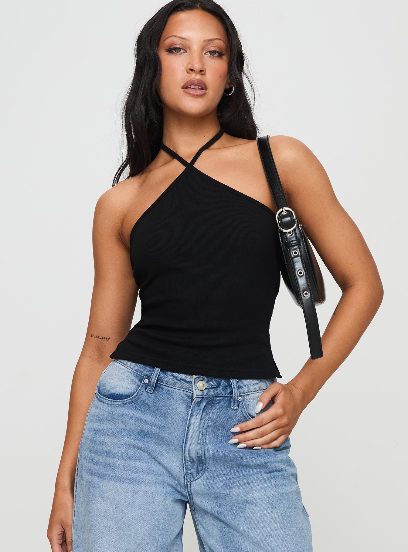 front view of model wearing Princess Polly Baseline Halter Rib Top Black Sleeveless 