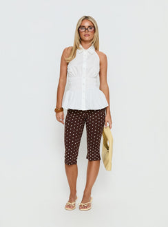 side view of model wearing Princess Polly Samaira Capri Pant Brown Polka Dot Mid Rise Pants 