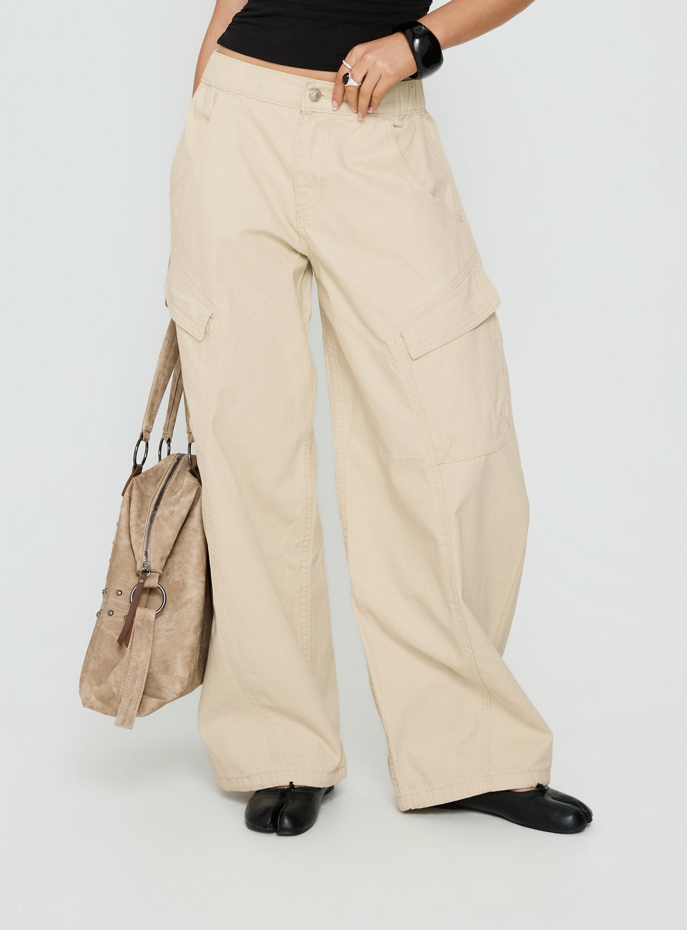 side view of model wearing Princess Polly Selective Memory Low Rise Wide Leg Cargo Pants Cream Low Rise Pants 