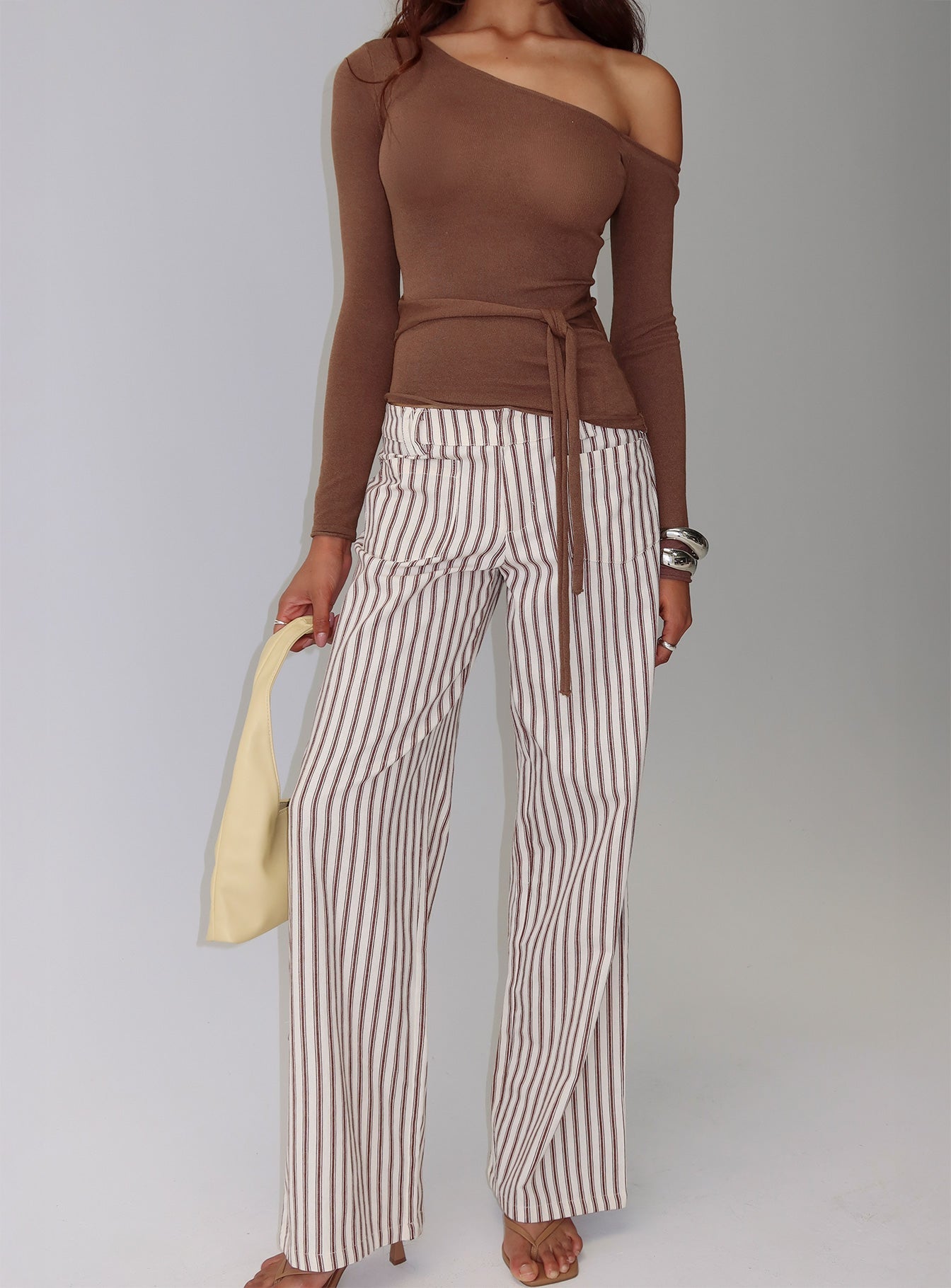 back view of model wearing Princess Polly Vendi Low Rise Pant Brown Stripe Low Rise Pants 