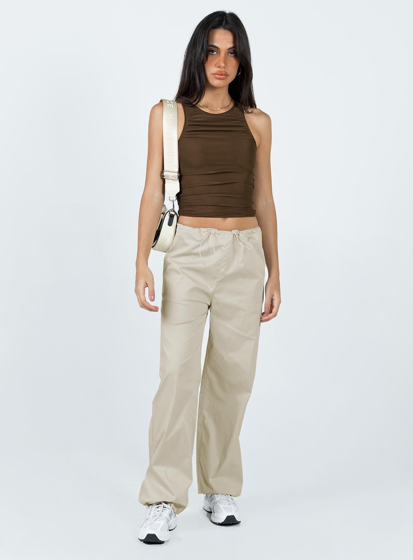 Front view of model wearing  front Princess Polly High Waisted Pants  Connels Parachute Pants Beige