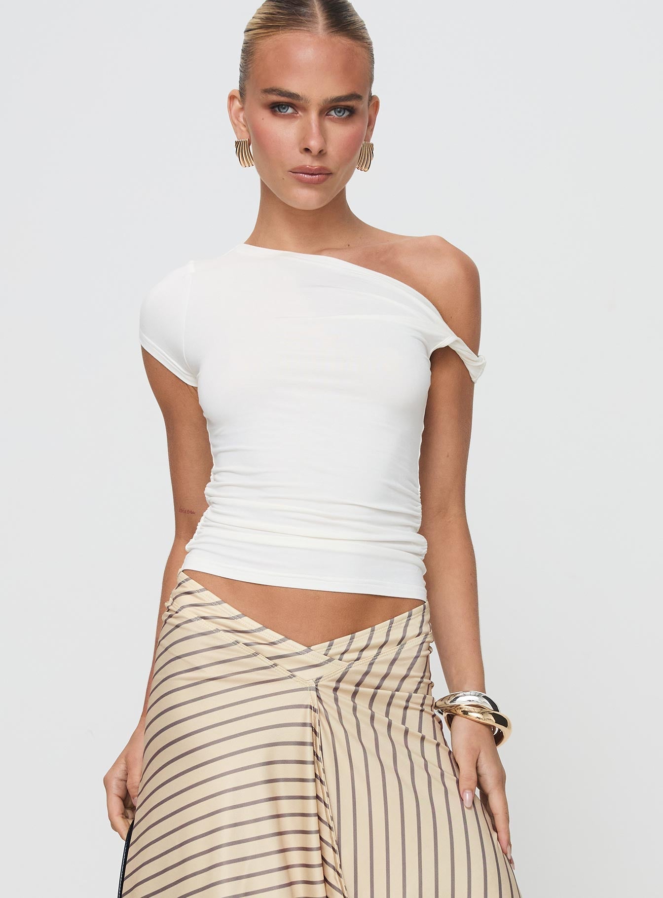 front view of model wearing Princess Polly Fabre Top White Short Sleeves Asymmetric Neckline 