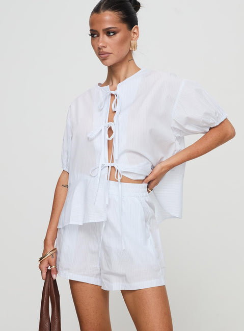 side view of model wearing Princess Polly Sunblind Shorts White High Waisted Shorts 