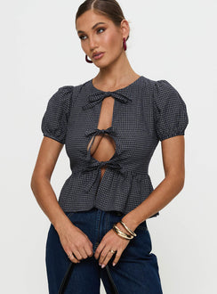 front view of model wearing Princess Polly Verah Tie Up Puff Sleeve Top Navy Check Short Sleeves Scoop Neck 