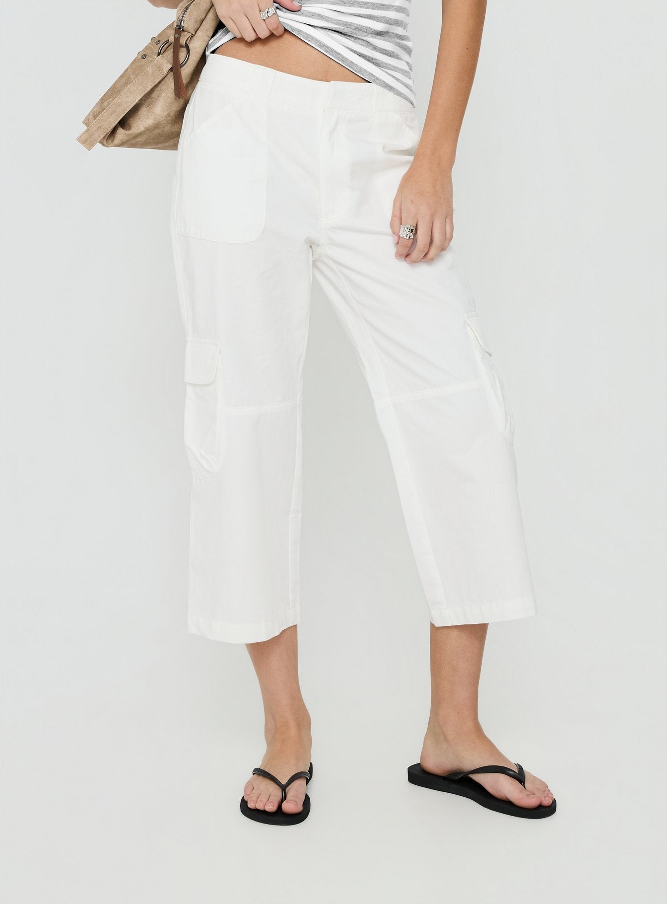 Featuring the Indee Cropped Cargo Pants White womens-regular-pants with high-rise back view of model wearing Princess Polly