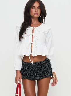 side view of model wearing Princess Polly Bebe Mini Skort Onyx Polka Low Rise Shorts 